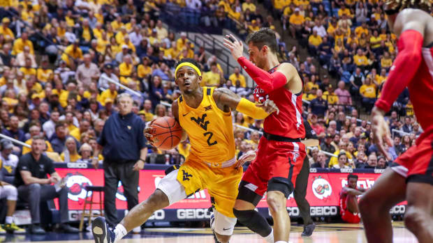 West Virginia Mountaineers guard Brandon Knapper (2) drives down the lane and is defended by Texas Tech Red Raiders guard Davide Moretti (25) during the second half at WVU Coliseum.